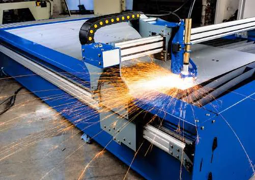 Laser cutting machine in operation with sparks